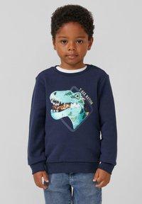 Marineblauer Sweater mit einem T-Rex-Graphic aus Pailletten, runden Ausschnitt und langen Ärmeln. Weicher Stoff mit gerippten Bündchen und Saum.