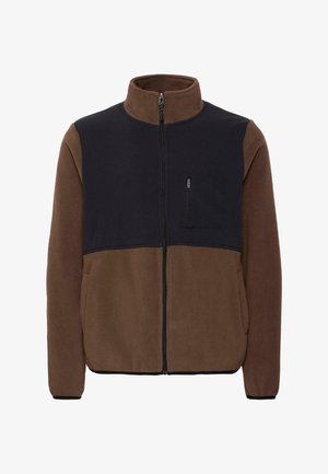 Flis jakna s tamnoplavim gornjim dijelom i smešnim donjim dijelom, ima zatvarač sprijeda, džep na prsima sa zatvaračem i crnu obrubu oko manžeta.