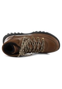 Brown leather hiking boot with a black rubber sole, tan laces, and gold eyelets. Features a padded collar and textured surface for grip.