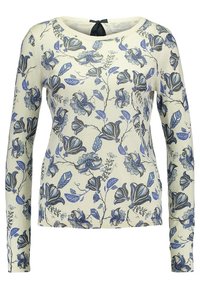 Cremefarbener Pullover mit langen Ärmeln, blauen und grauen Blumen- und Blattmustern, rundem Ausschnitt und schwarzem Satinband zum Binden im Rücken.