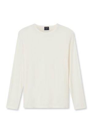 Chemise blanche à manches longues avec col rond et coupe ajustée, présentée sur un fond uni, avec une petite étiquette noire au niveau du col.