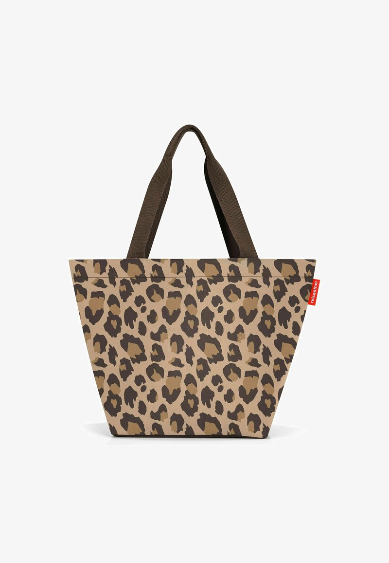 Leopard print tote bag featuring a tapered shape, brown fabric straps, and a durable canvas material with dark brown accents.