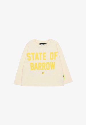 Lichtgeel overhemd met lange mouwen met "STATE OF BARROW" in vette gele letters op de voorkant gedrukt. Voorzien van drukknoopsluitingen op de schouder.