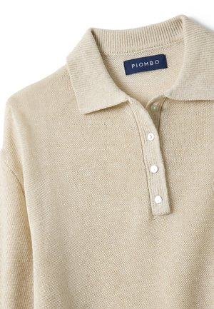 Polo de manga larga de punto beige con cuello acanalado y tres botones blancos en la tapeta.