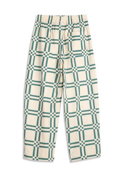 Pantalon couleur crème avec taille élastique et motif quadrillé vert, avec une seule poche arrière côté droit.