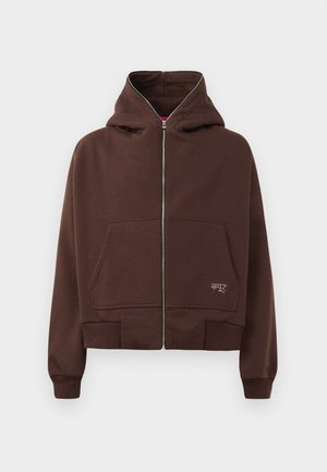 Brown zip-up hoodie with a drawstring hood, two front pockets, and ribbed cuffs. Features a small logo in white on the lower side.