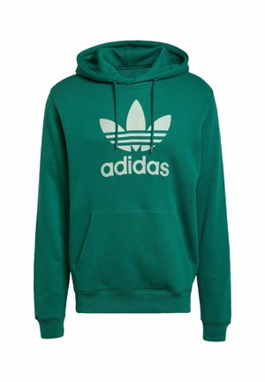 Zeleni Adidas hoodie iz mehkega materiala, s velikim belim logotipom in obliko treh črt na sprednji strani, z žepom za kenguru.