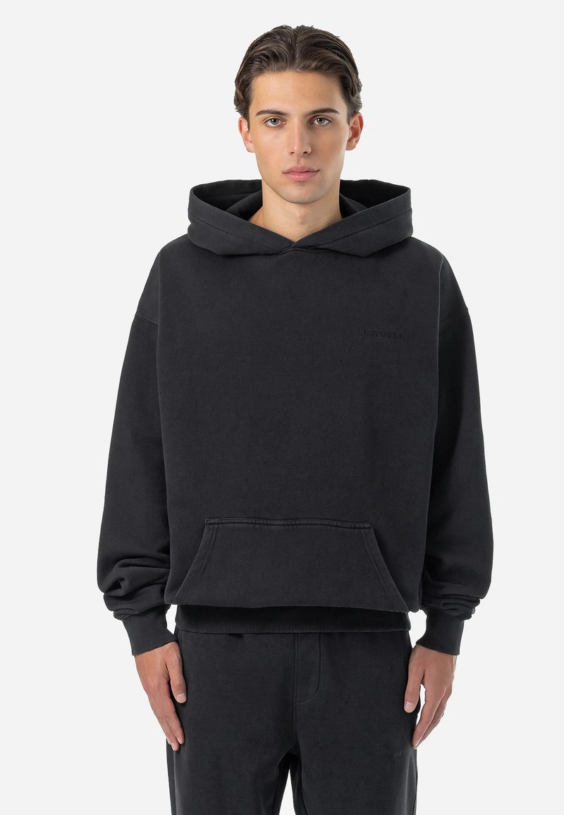 Black hoodie made of soft cotton fabric, featuring a large front pocket, drawstring hood, and ribbed cuffs and hem. Simple, unembellished design.
