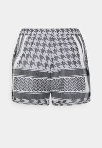 Šortky s černobílým vzorem s houndstooth a zigzag designy, elastickým pasem a měkkým textilním materiálem s ohrnutými okraji.