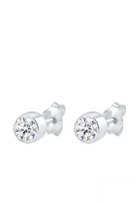 Boucles d'oreilles en argent sterling avec des pierres en zircon cubique transparent rondes, finition polie et fermoirs papillon pour un port sécurisé.