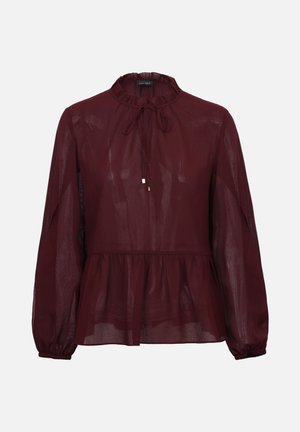 Blusa burdeos con cuello alto, cordón ajustable y bajo volante fruncido. Cuenta con mangas largas con puños elásticos y textura translúcida.