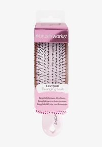 Detangling brush with a pink handle and a rectangular head featuring flexible black bristles. Packaged in a clear box with multi-language text.