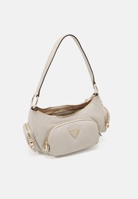 Borsa a spalla in nylon beige con finiture dorate, due scomparti con zip, una tasca frontale e una tracolla curva con rifiniture scure.