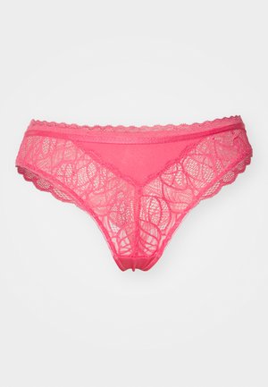 Pink lace thong with scalloped edges, featuring intricate leaf patterns and a soft texture. Designed for a fitted shape.