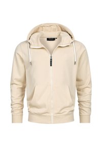 Beige zip-up hoodie met een zachte textuur, verstelbare trekkoorden aan de capuchon, twee steekzakken aan de voorkant en geribde manchetten. Subtiel merklogo op de borst.