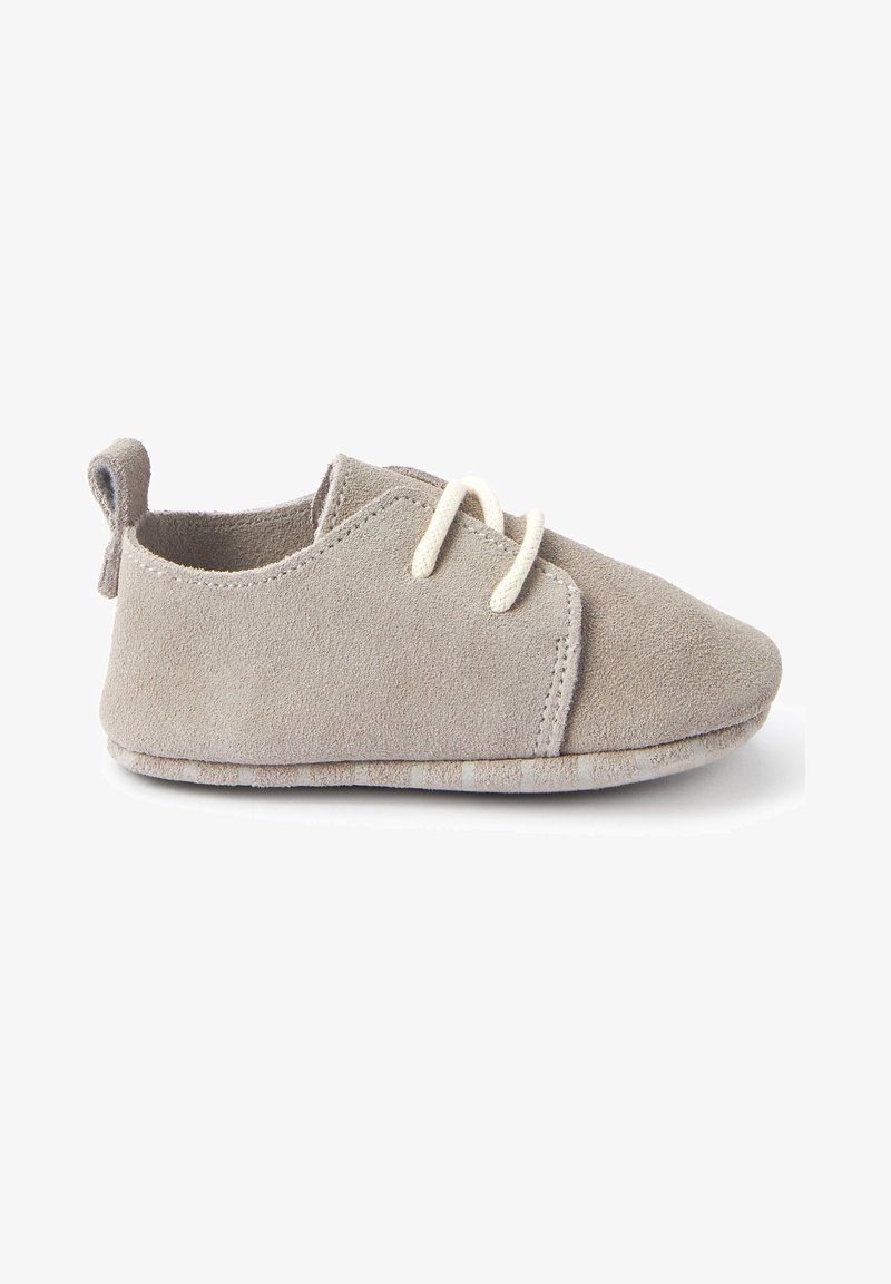 Gray suede shoe with a soft texture, featuring a rounded toe, lace-up design, and a small heel tab. Subtle stitching detail on sides.
