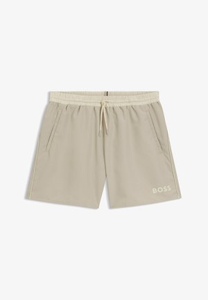 Shorts de bain pour hommes beiges avec taille élastique, cordon de serrage, poches latérales et logo "BOSS" sur la jambe gauche.