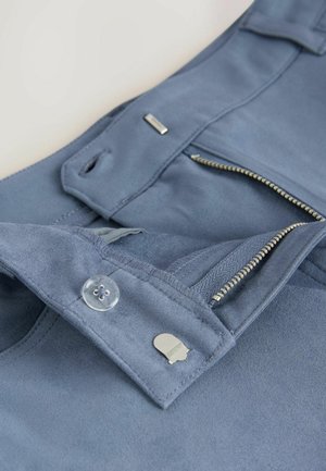 Blue suede pants featuring a zippered closure, clear button, and silver hardware. Smooth texture with stitched detailing and side pockets.