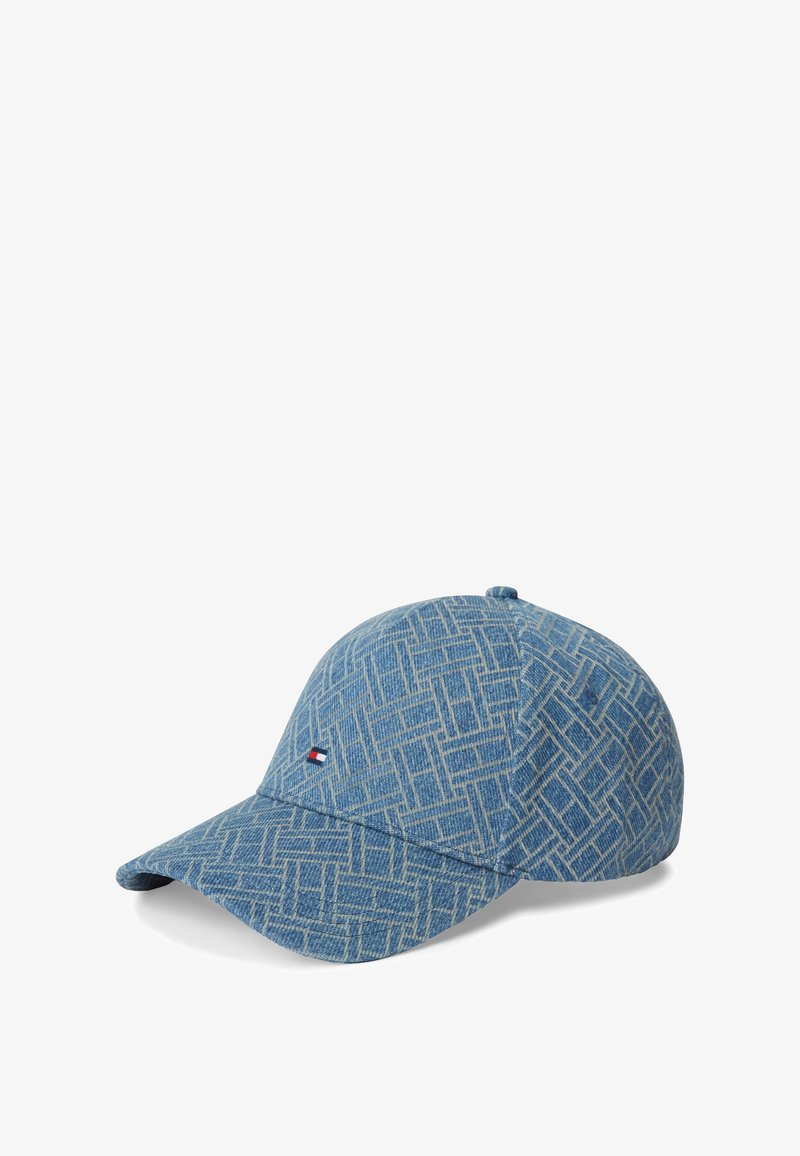 Casquette de baseball bleue avec un motif géométrique, fabriquée en tissu ressemblant au denim. Présente une petite étiquette logo sur le devant et une visière courbée.