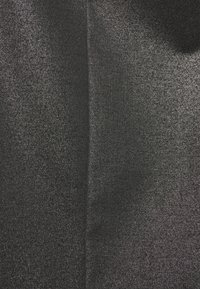 Black fabric with a metallic shimmer, displaying a textured surface. The design is smooth with subtle variations in tone and light reflection.