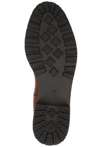 La semelle en cuir de la chaussure présente un crantage noir en caoutchouc robuste avec des motifs détaillés, y compris des formes d'étoiles et des rainures, marquée de la taille 37.