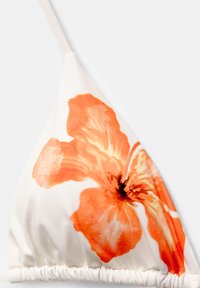 Triangle bikini top in white fabric featuring a large, orange floral print. The material is smooth with a gathered seam at the bottom.