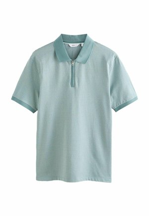 Kortærmet, lyseblågrøn poloshirt med tekstureret stof, lynlåslukning i kraven og kontrastfarvede kanter på kraven og ærmekanterne, vist på hvid baggrund.