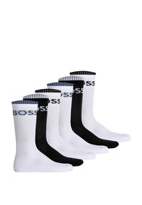 Set of five socks: two black, three white. Ribbed texture, crew-length design, featuring "BOSS" logo printed on the cuff in contrasting colors.