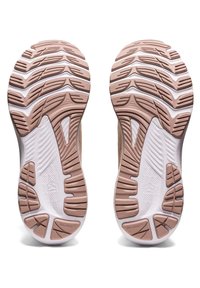 Semelle en caoutchouc de couleur beige et blanche, présentant un motif de bande de roulement multidirectionnel pour une traction et une stabilité optimales. Détails de surface texturée.