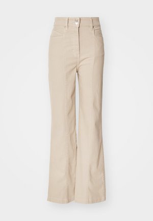 Beige high-waisted flared trousers made of cotton blend, featuring front pockets, a zip fly, and a silver button detail at the waist.