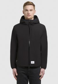 Black zip-up jacket with a hood, featuring elastic cuffs, a front pocket, and a logo patch at the hem. Smooth, lightweight fabric.