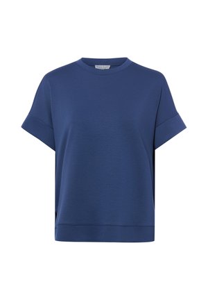 Blauw losvallend shirt met korte mouwen, ronde hals, omgeslagen manchetten en een brede zoom aan de onderkant, getoond tegen een witte achtergrond.
