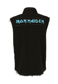 Fekete, ujjatlan trikó, rojtos szélekkel. A hátsó oldalon nagy kék "IRON MAIDEN" felirat található, vastag, stilizált betűtípussal. Pamut anyag.