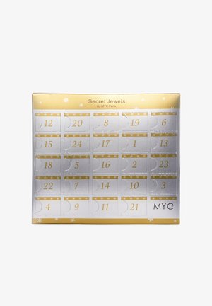 Schmuck-Adventskalender von MYC Paris, mit einem goldenen und silbernen Design, nummerierten Türen und Schneeflockenmuster auf einer rechteckigen Box.