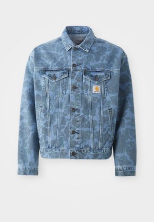 Denim jacket featuring a blue camouflage pattern, two chest pockets, metal buttons, and a Carhartt logo patch on the left pocket.