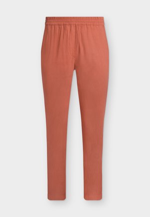 Rust-colored slim-fit pants with elastic waistband and subtle front seam detailing, displayed on a plain white background.