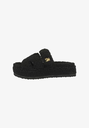 Black slide sandals with a textured, fuzzy fabric upper and a patterned rubber sole. Features a gold logo on the strap.