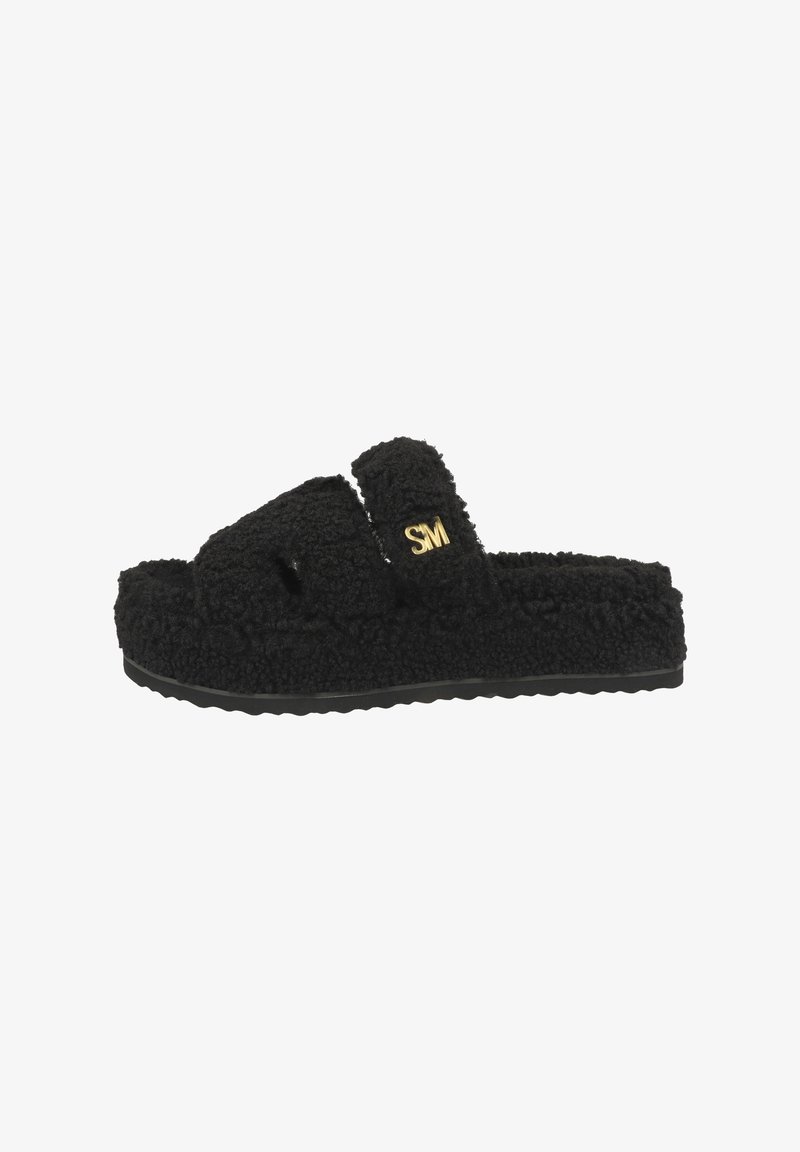 Sandales noires à glissière avec une partie supérieure en tissu texturé et moelleux et une semelle en caoutchouc à motifs. Présente un logo doré sur la sangle.