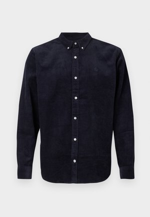 Navy corduroy button-up shirt with long sleeves, a button-down collar, and white buttons; features subtle texture and a logo on the chest.