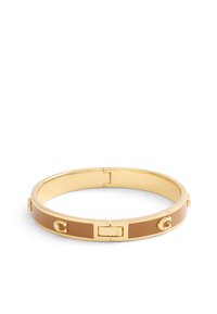 Gold bangle bracelet featuring a brown enamel band, secured with a clasp. Notable accents include small circular studs and a logo detail.