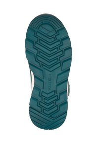 Suela de zapato verde azulado con un patrón de surcos profundos y angulares, y "TROLLKIDS" grabado en el centro, aislada sobre un fondo blanco.