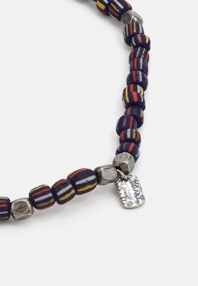 Beaded necklace with purple and multi-colored patterned beads, interspersed with textured silver accent beads and a small engraved tag.