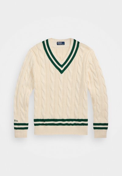 Cream v-neck sweater with cable knit pattern, green and white striped collar and waistband, featuring "Polo" embroidered on the sleeve.