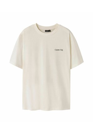 Kremfarget T-skjorte med korte ermer og rund hals, liten svart «Country Club»-tekst på venstre bryst og LMTD-merke inne i kragen.