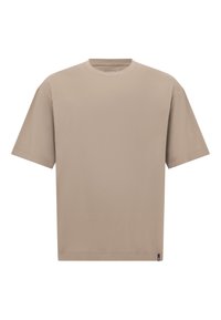Bežové oversized tričko vyrobené z měkké bavlny, s kulatým výstřihem a krátkými rukávy, má rovný lem a minimální branding na boku.