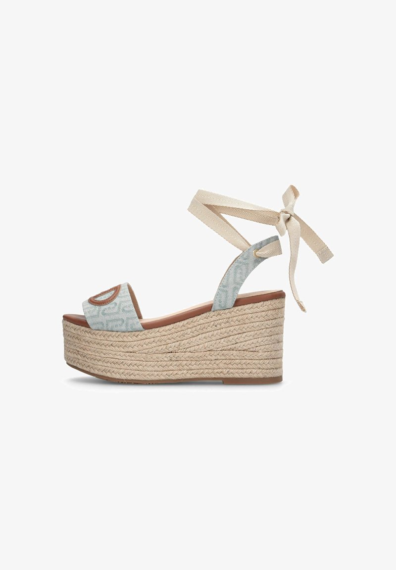 Sandale espadrille compensée avec des brides en tissu à motifs bleu clair, un lien beige à la cheville et une semelle plateforme en jute tressé.
