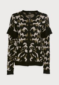 Cardigan negro con cremallera, con estampado de animales en verde y plata, mangas con volantes y botones metálicos en los bolsillos. Textura de tejido suave.