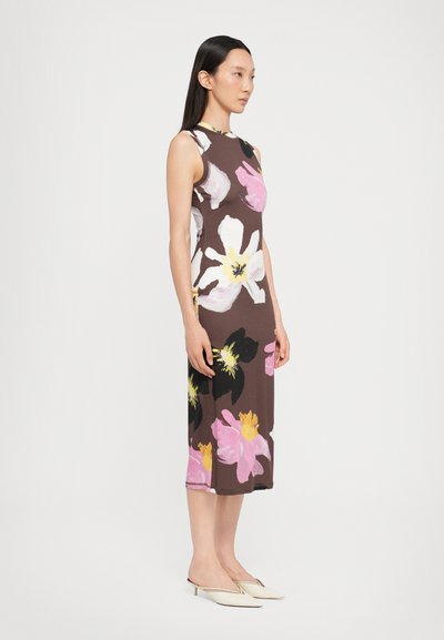 Sleeveless brown dress with white and pink floral pattern, mid-length, smooth texture. Paired with pale slip-on shoes, model standing sideways.