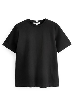 T-shirt noir à manches courtes en coton doux. Encolure ronde, coupe décontractée, avec des détails de surpiqûres discrètes à l'ourlet et aux manches.