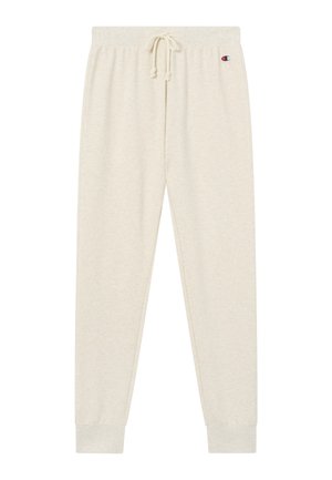 Beżowe spodnie dresowe z elastycznym ściągaczem w talii, prążkowanymi mankietami oraz małym logo Champion po lewej stronie u góry.